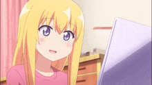 a girl with blonde hair and blue eyes is looking at a laptop screen