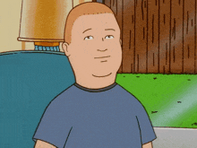a cartoon character named king of the hill is sitting on a couch