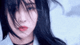 a close up of a woman 's face with her hair blowing in the wind and red lips .