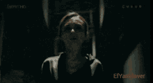 a man and a woman are walking through a hallway with the word ever on the bottom left