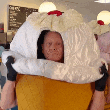 a man in an ice cream cone costume stands in front of a sign that says coffee