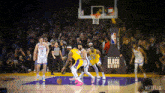 a basketball game is being played in front of a sign that says built by black history