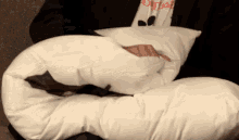 a person laying on a pillow with a shirt that says ' i love ' on it