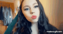 a close up of a woman 's face with make a gif.com in the bottom right corner