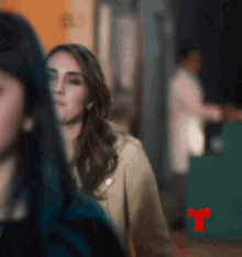 a blurred image of a woman with a red r on the bottom right