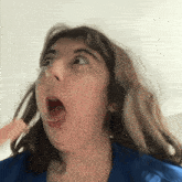 a girl with her mouth wide open looks surprised