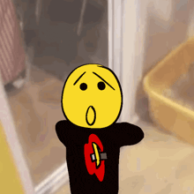 a cartoon drawing of a smiley face wearing a black shirt with a g on it