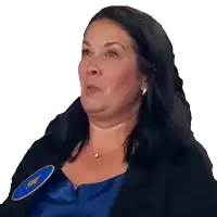 a woman wearing a blue shirt and a black jacket has a name tag that says sue