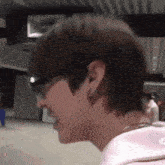 a close up of a person wearing glasses and a pink shirt