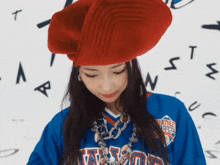 a woman wearing a red beret and a blue shirt that says ' weather chasers ' on it
