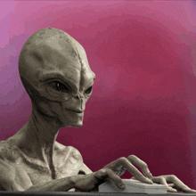 an alien is typing on a computer keyboard