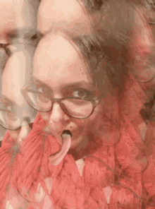 a woman with glasses and a red scarf sticking her tongue out