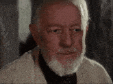 a man with a beard and gray hair is looking down