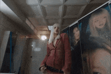 a woman with white hair and red lipstick is wearing a red jacket