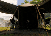 a dark tent with a lantern hanging from the roof