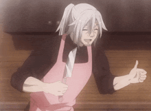 a man wearing a pink apron holds a knife and gives a thumbs up