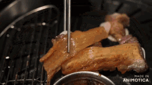 a piece of meat is being eaten with chopsticks and the words made in animotica are on the bottom