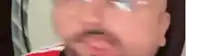 a bald man with a beard is drinking a coke from a straw .