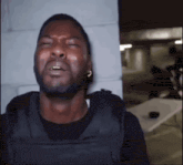 a man wearing a bullet proof vest is crying