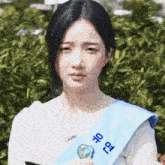 a woman wearing a sash that says seoul on it