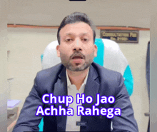 a man in a suit is sitting in front of a sign that says consultation fee