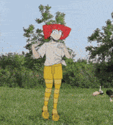 a girl with red hair and yellow shorts stands in a grassy field