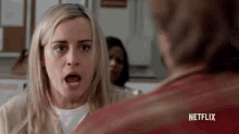 a woman is talking to a man with netflix written on the bottom