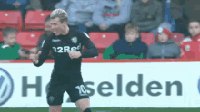 a soccer player with the number 10 on his shorts is running on the field