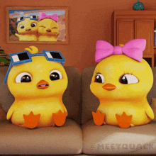 a couple of cartoon ducks are sitting on a couch