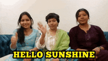 three women sitting on a couch with the words hello sunshine written above them