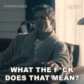 a man in a robe is sitting in a chair with the words what the f * ck does that mean