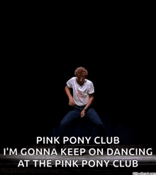 a man is dancing on a stage with the words `` pink pony club '' written on it .