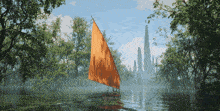 a boat with an orange sail is floating on a lake surrounded by trees