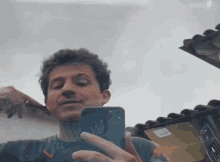a man is taking a selfie with his cell phone .