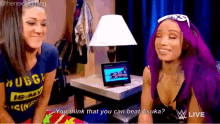 two women with purple hair are sitting next to each other and one of them says " you think that you can beat asuka "