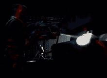 a man in a knight 's armor is holding a flamethrower
