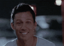 a close up of a man 's face smiling