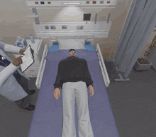 a man is laying in a hospital bed while a doctor looks at a clipboard