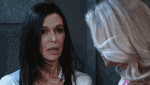 two women are talking to each other and one has a nose ring on her nose
