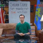 sheldon cooper is sitting on a couch in front of a whiteboard that says fun with flags