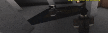 a man in a suit is standing in a room in a video game while another man is laying on the floor .