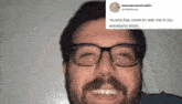 a man with glasses and a beard is smiling and talking .