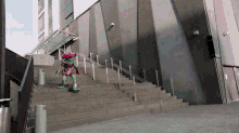 a mascot is riding a skateboard down a set of stairs in front of a building