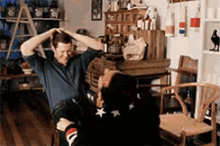 a man is sitting on a woman 's lap in a living room