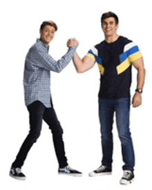 two men are standing next to each other and giving each other a high five .