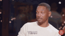 a man in a white shirt says " yeah "