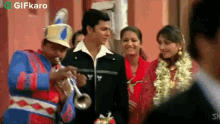 a man playing a trumpet in front of a group of people