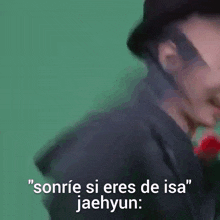 a man wearing a hat with the words sonrie si eres de isa jaehyun