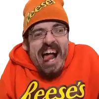 a man wearing a reese 's hoodie and a beanie