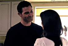 a man and a woman are looking into each other 's eyes and the words cwsupermangifs are visible in the corner